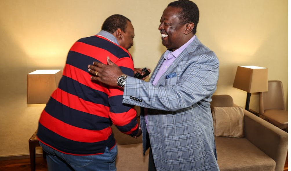 Uhuru Kenyatta exchange pleasantries with Mudavadi in Nigeria