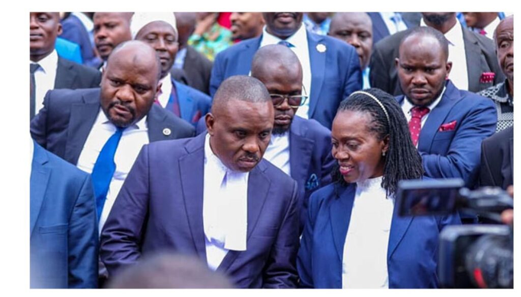Lawyers representing veteran opposition leader Kizza Besigye walks out of court in protest of ruling on Karua absence.