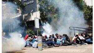 Police lob tear gas to disperse peaceful protesters marching to State House
